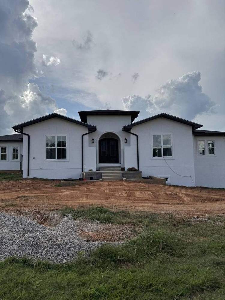 White stucco custom home with arched entry