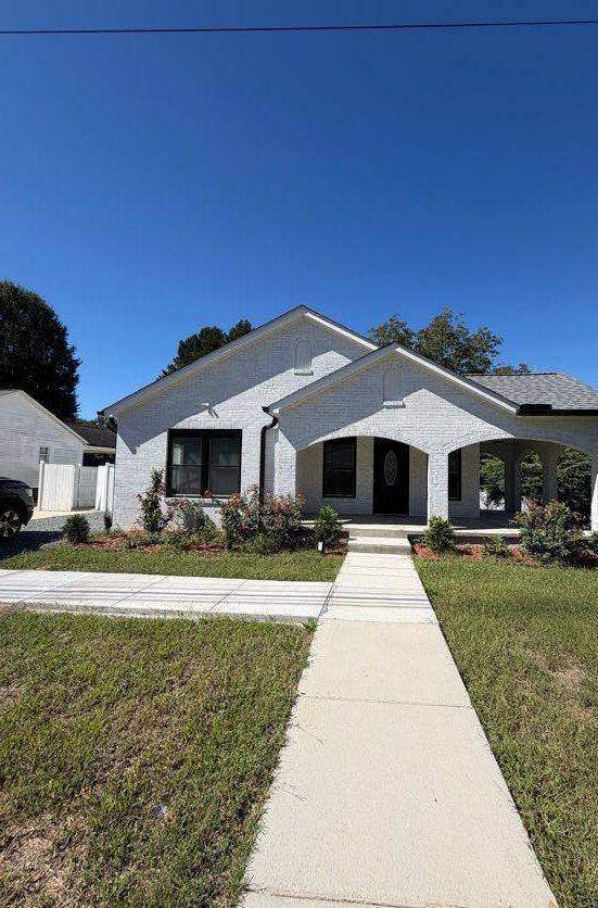 Front of the remodeled Landis home with arched porch and new walkway