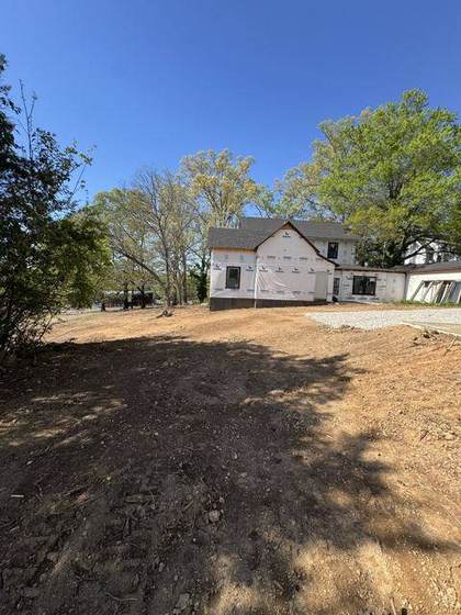The house wrapped, seen from the graded lot