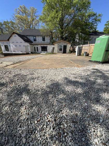 Gravel parking area behind the house
