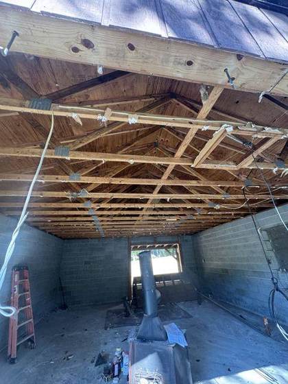 Inside the garage before: block walls and open trusses
