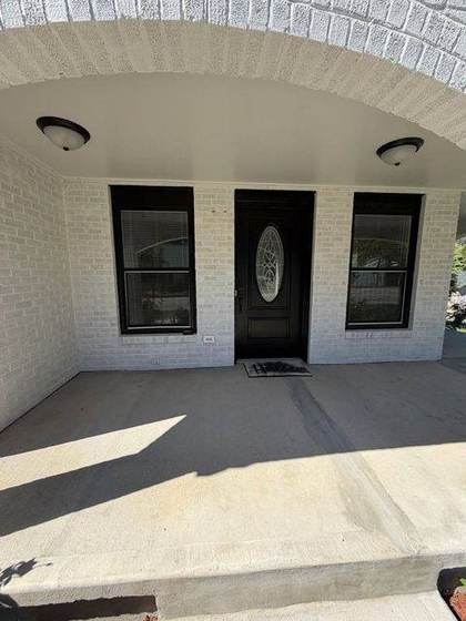 New front door with sidelights under the porch