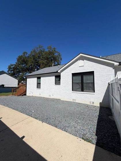 Side of the home and gravel drive