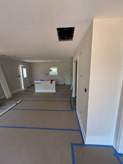 Open living area with drywall finished and painted