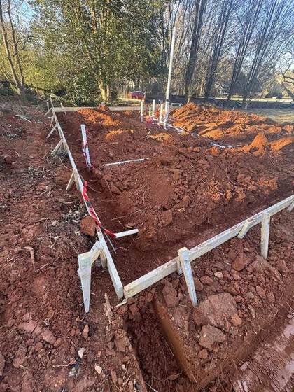 Footing trenches and forms with grade stakes