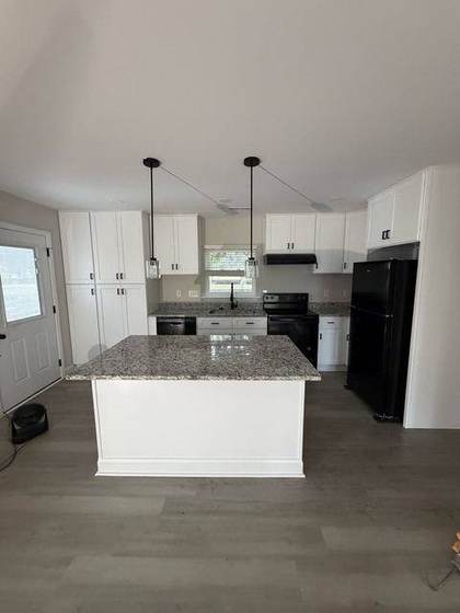 Finished kitchen with island and pendant lights