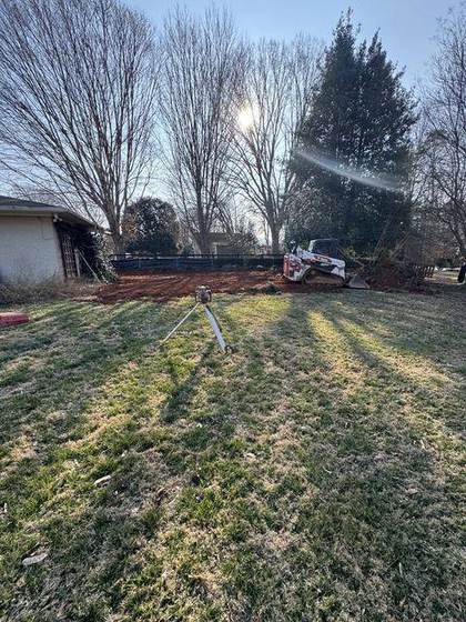 Cleared backyard lot with stakes set