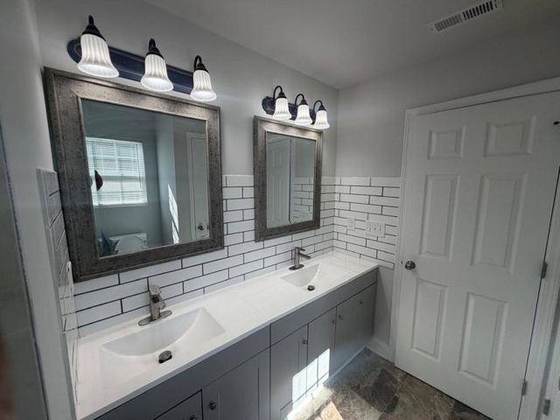 Bathroom with double vanity and subway tile