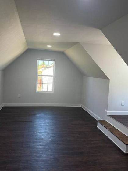 Bonus room with vaulted ceiling and dormers