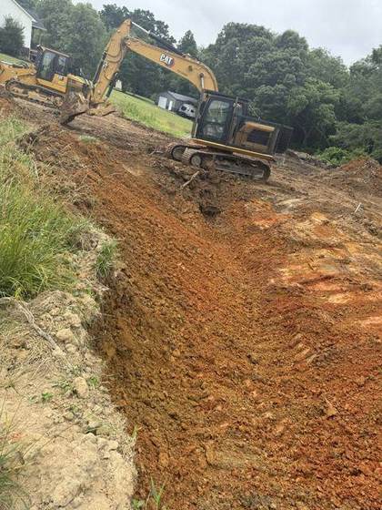 Grading the pad in red clay