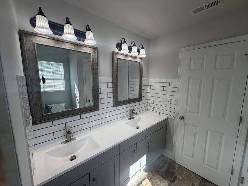 Bathroom with double vanity and subway tile